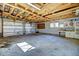 Spacious garage with exposed beams, cabinets, and shelving at 11540 Inspiration Rd, Golden, CO 80403