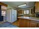 Traditional kitchen with wood cabinets, laminate counters, island, and a window overlooking the outdoors at 11540 Inspiration Rd, Golden, CO 80403