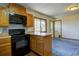 Cozy kitchen with wooden cabinets, modern appliances, tile backsplash, and exterior access at 11540 Inspiration Rd, Golden, CO 80403