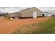 Exterior shot of the barn shows paint and barn door access from a dirt drive at 3530 Doolittle Rd, Monument, CO 80132