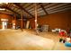 Spacious barn interior with wooden beams and high ceilings, offering ample storage and workspace at 3530 Doolittle Rd, Monument, CO 80132
