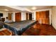 Finished basement featuring a covered pool table on a wood floor and access to storage at 3530 Doolittle Rd, Monument, CO 80132