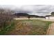Scenic view of the home's exterior with white fencing and mountain backdrop, blending rural charm at 3530 Doolittle Rd, Monument, CO 80132