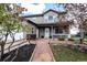 Charming home featuring stone accents, well-maintained landscaping, and a welcoming front porch at 3530 Doolittle Rd, Monument, CO 80132