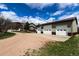 View of a large, detached garage with multiple bays and solar panels on the roof at 3530 Doolittle Rd, Monument, CO 80132