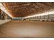 Bright indoor riding arena with sand, equipment and high ceilings, ideal for equestrian activities at 3530 Doolittle Rd, Monument, CO 80132