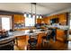 Bright kitchen with granite countertops, a breakfast bar, and wood cabinetry at 3530 Doolittle Rd, Monument, CO 80132