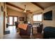 Cozy living room with vaulted ceilings, wooden beams, and comfortable seating with a rustic appeal at 3530 Doolittle Rd, Monument, CO 80132