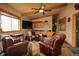 Inviting living area featuring leather seating, wood accents, and a ceiling fan offering a cozy ambiance at 3530 Doolittle Rd, Monument, CO 80132
