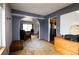 A modern living room with dark-blue accent wall, archway, and view of the kitchen at 3530 Doolittle Rd, Monument, CO 80132