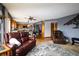 View of the living area and kitchen with wood floors and comfortable seating at 3530 Doolittle Rd, Monument, CO 80132