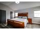 Main bedroom with a bed, and side tables under windows with custom headboard at 3530 Doolittle Rd, Monument, CO 80132