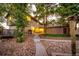 Backyard with landscaping, patio, upper deck, and lots of trees at 9404 Devils Head Dr, Parker, CO 80138