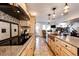 Modern kitchen featuring custom cabinets, granite countertops, stainless appliances, and a view of the home's open floor plan at 9404 Devils Head Dr, Parker, CO 80138