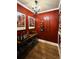 Wine cellar with rich red walls, black iron wine racks, and recessed lighting, perfect for wine enthusiasts at 9404 Devils Head Dr, Parker, CO 80138