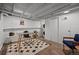 Finished basement with white-painted brick and ceiling, plus bonus area with desk at 3003 California St, Denver, CO 80205