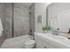 Well-lit bathroom features modern gray tile, updated vanity, and sleek mirror at 3003 California St, Denver, CO 80205