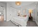 Comfortable bedroom with neutral decor, contemporary lamps, and a sliding door closet at 3003 California St, Denver, CO 80205