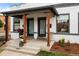 Inviting porch with stylish decor, natural wood accents, and fresh landscaping enhancing curb appeal at 3003 California St, Denver, CO 80205