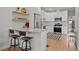 Modern kitchen featuring white cabinetry, stainless steel appliances, and stylish breakfast bar at 3003 California St, Denver, CO 80205