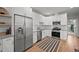 Bright kitchen featuring white cabinets, stainless appliances, and modern finishes at 3003 California St, Denver, CO 80205