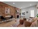 Bright living area showcasing a decorative brick wall with a fireplace and hardwood floors at 3003 California St, Denver, CO 80205