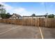 Rear parking area with secure privacy fence and yellow lane markers at 3003 California St, Denver, CO 80205
