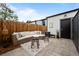 Private backyard patio with outdoor seating, privacy fence, and modern storage unit at 3003 California St, Denver, CO 80205