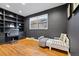 Cozy bedroom with built-in shelving and hardwood floors at 6600 E 8Th Ave, Denver, CO 80220