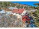 Two-story home with deck and red accents in a snowy mountain setting at 347 Buena Vista, Palmer Lake, CO 80133