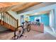 Finished basement recreation room with exercise equipment and stairs at 347 Buena Vista, Palmer Lake, CO 80133