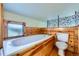 Bathroom with soaking tub and wood-paneled walls at 347 Buena Vista, Palmer Lake, CO 80133