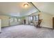 Large bonus room with two rocking chairs and abundant natural light at 347 Buena Vista, Palmer Lake, CO 80133