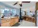 Open kitchen with light blue walls, wood cabinets, and a view to the living room at 347 Buena Vista, Palmer Lake, CO 80133