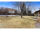 Large, grassy backyard area, perfect for outdoor activities or entertaining, with privacy fencing and mature trees at 3680 S Pontiac Way, Denver, CO 80237