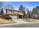 Charming two-story home featuring a brick facade, attached two-car garage, and a well-maintained front yard at 3680 S Pontiac Way, Denver, CO 80237