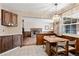 Bright kitchen with a view into a cozy living area with a brick fireplace at 3680 S Pontiac Way, Denver, CO 80237