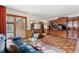 Spacious living room featuring hardwood floors, a fireplace, and an open view to the kitchen at 3680 S Pontiac Way, Denver, CO 80237