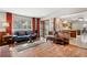 Cozy living room adjacent to the kitchen, featuring a sliding glass door and hardwood floors at 3680 S Pontiac Way, Denver, CO 80237