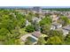 An aerial view shows community pool and surrounding neighborhood, with mature trees and manicured lawns at 9255 E Lehigh Ave # 208, Denver, CO 80237
