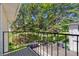 A balcony view shows mature trees and green space for outdoor enjoyment and relaxation at 9255 E Lehigh Ave # 208, Denver, CO 80237