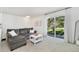 Living room with a grey couch, a white coffee table, and sliding glass doors leading to a balcony at 9255 E Lehigh Ave # 208, Denver, CO 80237