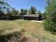 Spacious backyard showing a patio, a wooden fence, and mature trees, perfect for outdoor living and recreation at 8491 W Star Cir, Littleton, CO 80128