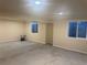 A spacious basement showcasing a concrete floor and two windows for ample natural light at 8491 W Star Cir, Littleton, CO 80128