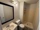 A cozy bathroom showcasing a walk-in shower with light colored tiles at 8491 W Star Cir, Littleton, CO 80128