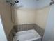 Bathroom featuring an updated shower and tub combination with tile backsplash and updated fixtures at 8491 W Star Cir, Littleton, CO 80128
