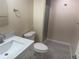 An updated bathroom with modern vanity, faucet, and shower with glass doors at 8491 W Star Cir, Littleton, CO 80128