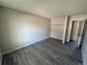 Bedroom with fresh paint, wood floors, a closet with bar for hangers, and lots of natural light at 8491 W Star Cir, Littleton, CO 80128