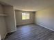 This bedroom boasts gray plank flooring and a window overlooking the backyard at 8491 W Star Cir, Littleton, CO 80128