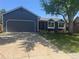 Charming single Gathering home with a well-manicured front yard, mature tree, and two car garage at 8491 W Star Cir, Littleton, CO 80128